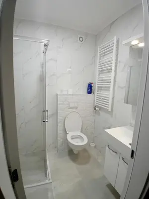 a bathroom with a toilet and a shower and a sink at Apartman Milan'o in Doboj