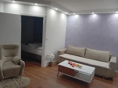 a living room with a couch and a chair and a table at Apartman Milan'o in Doboj