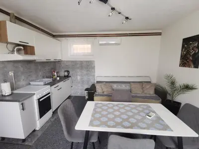 a kitchen and a living room with a table in a room at Sofyy in Banja Luka