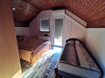 a small bedroom with a bed and a window at Sofyy in Banja Luka