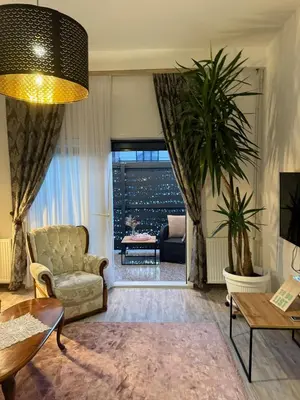 a living room with a couch and a chair at Apartman Tanzanija Bihać in Bihać