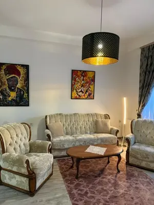 a living room with couches and a coffee table at Apartman Tanzanija Bihać in Bihać