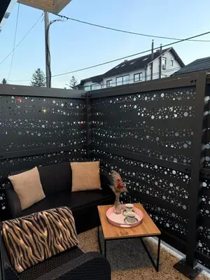 a balcony with a couch and a coffee table at Apartman Tanzanija Bihać in Bihać