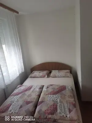 a bedroom with a bed with a quilt on it at Stan na dan Banja Luka in Banja Luka