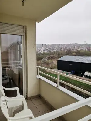 two white chairs sitting on a balcony with a view at Stan na dan Banja Luka in Banja Luka