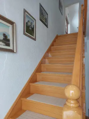 a staircase in a home with wooden steps at Apartman Vidikovac in Kupres