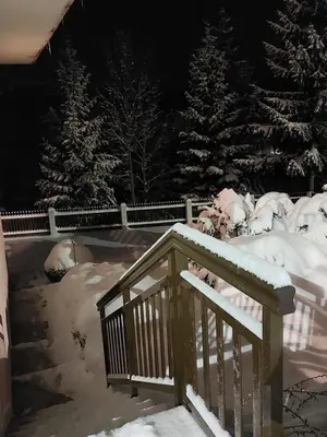 a staircase covered in snow next to some trees at Apartman Vidikovac in Kupres