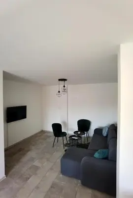 a living room with a couch and a table and chairs at Vila Nika in Banja Luka