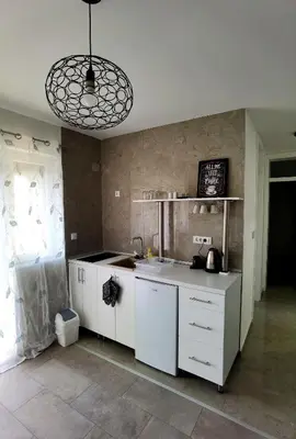 a kitchen with white cabinets and a sink at Vila Nika in Banja Luka