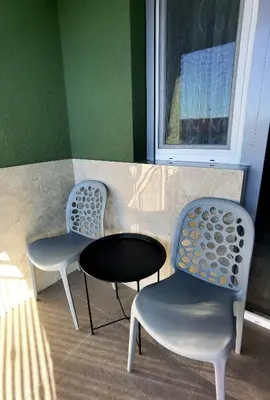 three chairs and a table in a room with a window at Vila Nika in Banja Luka