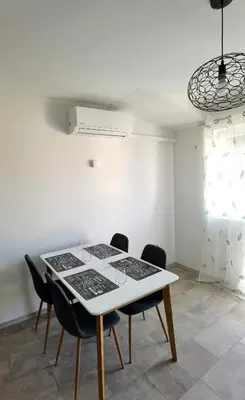 a dining room with a white table and chairs at Vila Nika in Banja Luka