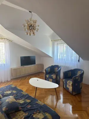 a living room with two chairs and a table at Grand apartman in Banja Luka