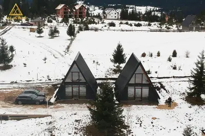 a house with a car parked in the snow at Weekend house - Vlašić in Vlasic