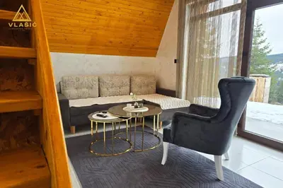 a living room with a couch and a table and a chair at Weekend house - Vlašić in Vlasic