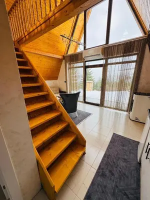 a bathroom with a wooden staircase in a house at Weekend house - Vlašić in Vlasic