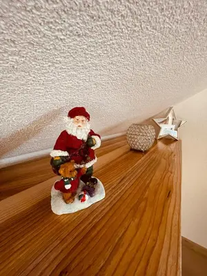 a santa claus figurine on the floor of a room at Apartman Vito in Kupres