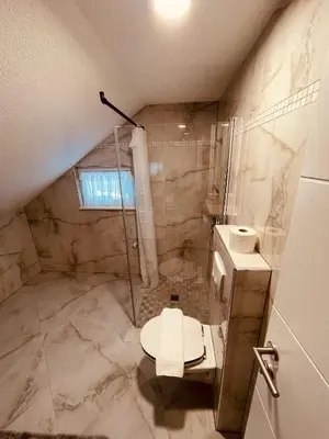 a bathroom with a shower and a toilet at Apartman Vito in Kupres