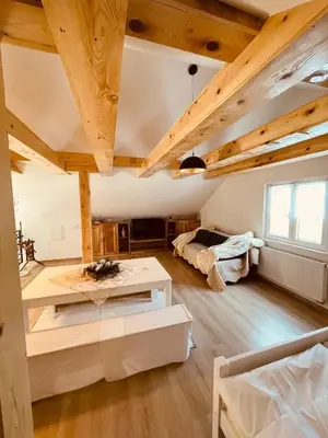 a room with two beds and a table in it at Apartman Vito in Kupres