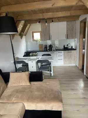a living room with a couch and a kitchen at Planinska kuća Marko in Vlasic