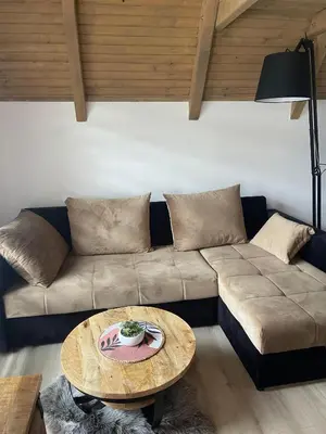 a living room with a couch and a table at Planinska kuća Marko in Vlasic