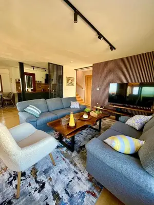 a living room with blue couches and a table at Villa Encian in Travnik