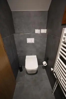 a bathroom with a white toilet in a room at Villa Encian in Travnik