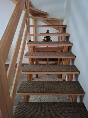 a set of stairs with wooden risers in a house at Apartman NANA Vlašić in Šišava