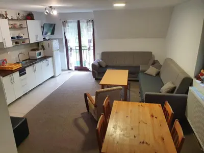 a living room with a couch and a table at Apartman NANA Vlašić in Šišava