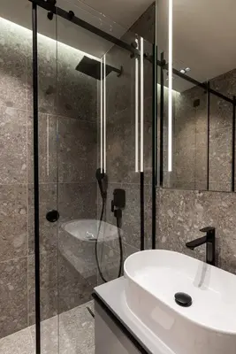 a bathroom with a sink and a glass shower at Garni Hotel Galeria in Banja Luka