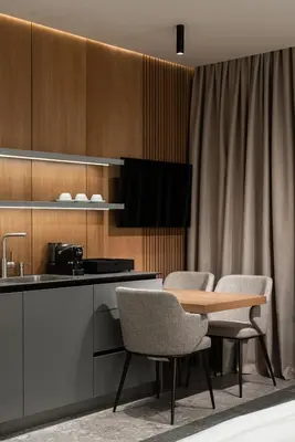 a kitchen with a table and chairs and a counter at Garni Hotel Galeria in Banja Luka
