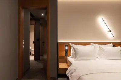 a bedroom with a large bed with white pillows at Garni Hotel Galeria in Banja Luka