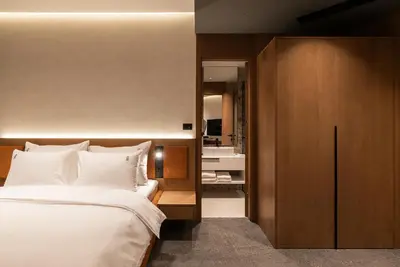 a bedroom with a large bed with white pillows at Garni Hotel Galeria in Banja Luka