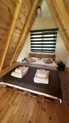 a bedroom with a large bed in a attic at Wellness Borealis in Tuzla
