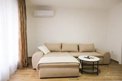 a living room with a couch and a table at Helvetia Apartments in Jajce