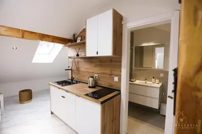 a kitchen with white cabinets and a sink at Helvetia Apartments in Jajce