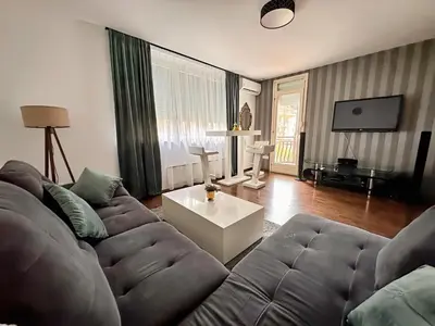 a living room with a couch and a table at Apartman The Bo in Prnjavor