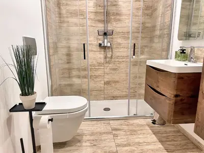 a bathroom with a shower and a toilet and a sink at Apartman The Bo in Prnjavor