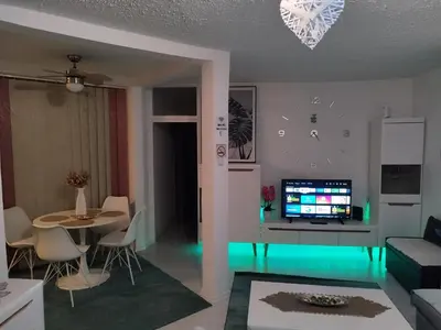 a living room with a couch and a table at Apartman San in Bihać
