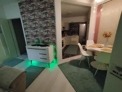 a living room with a table and a dining room at Apartman San in Bihać