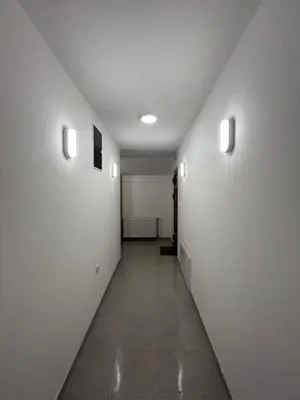 an empty hallway with white walls and a tile floor at Apartmani Karanovac in Banja Luka