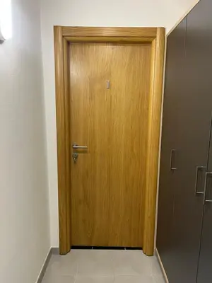a wooden door in the middle of a room at Apartmani Karanovac in Banja Luka