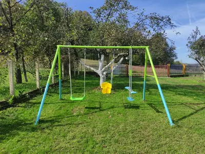 a swing set in a yard with a tree at Šumska Oaza in Laktaši