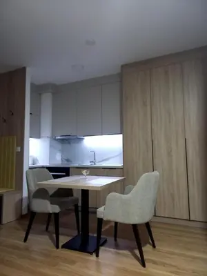 a kitchen with a table and chairs in a room at MN apartman in Banja Luka