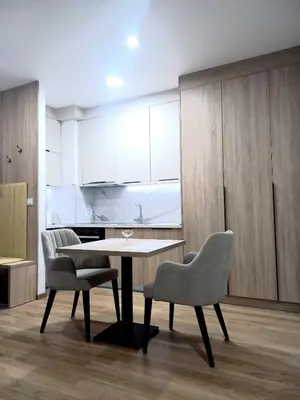 a dining room with a table and two chairs at MN apartman in Banja Luka