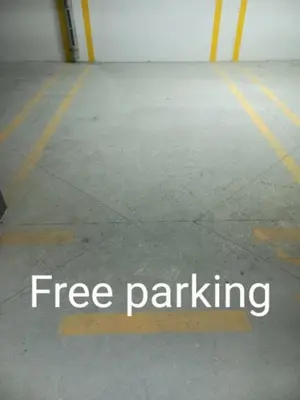 a free parking sign on the floor of a parking garage at MN apartman in Banja Luka