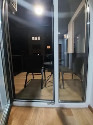 a view of a dining room from a glass door at MN apartman in Banja Luka