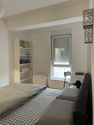 a bedroom with two beds and a window at Evergrey in Banja Luka