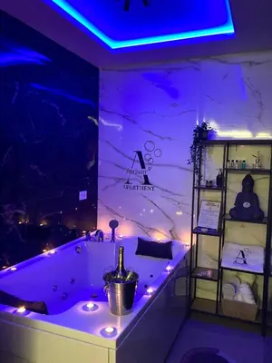 a bathroom with a tub with a bottle of wine in it at Apartman Atrium Banja Luka in Banja Luka
