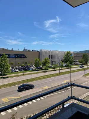 a car driving down a road in front of a building at Apartman Atrium Banja Luka in Banja Luka