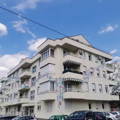 a tall white building with colorful decorations on it at Apartman Anja in Banja Luka